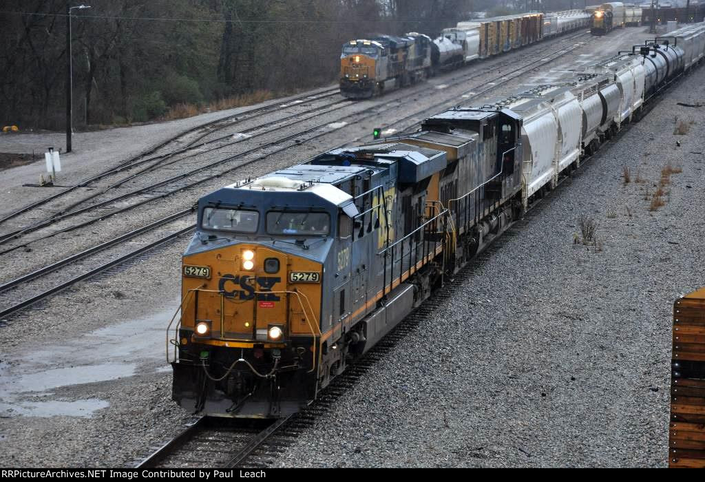 Manifest rolls north past the yard in the rain